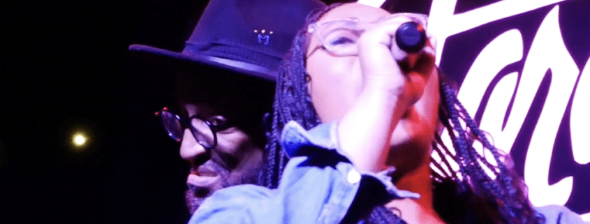 Singer performing on stage with microphone.